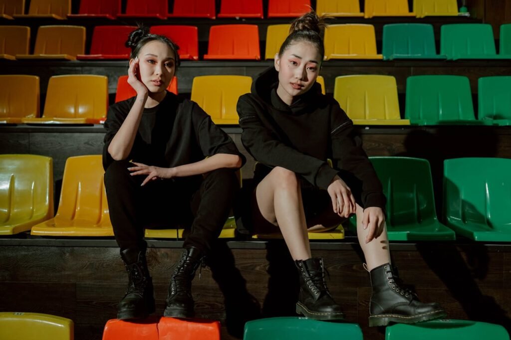 Women in Black Clothes Sitting Inside the Gym